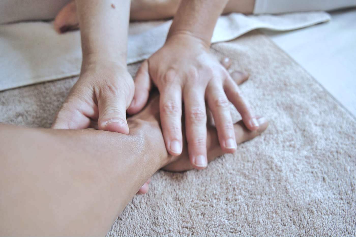 Physiotherapist's hands treating a patient's foot and ankle