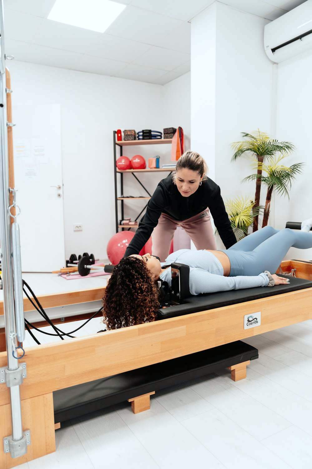 Physiotherapist guiding a patient through supervised rehabilitation exercises